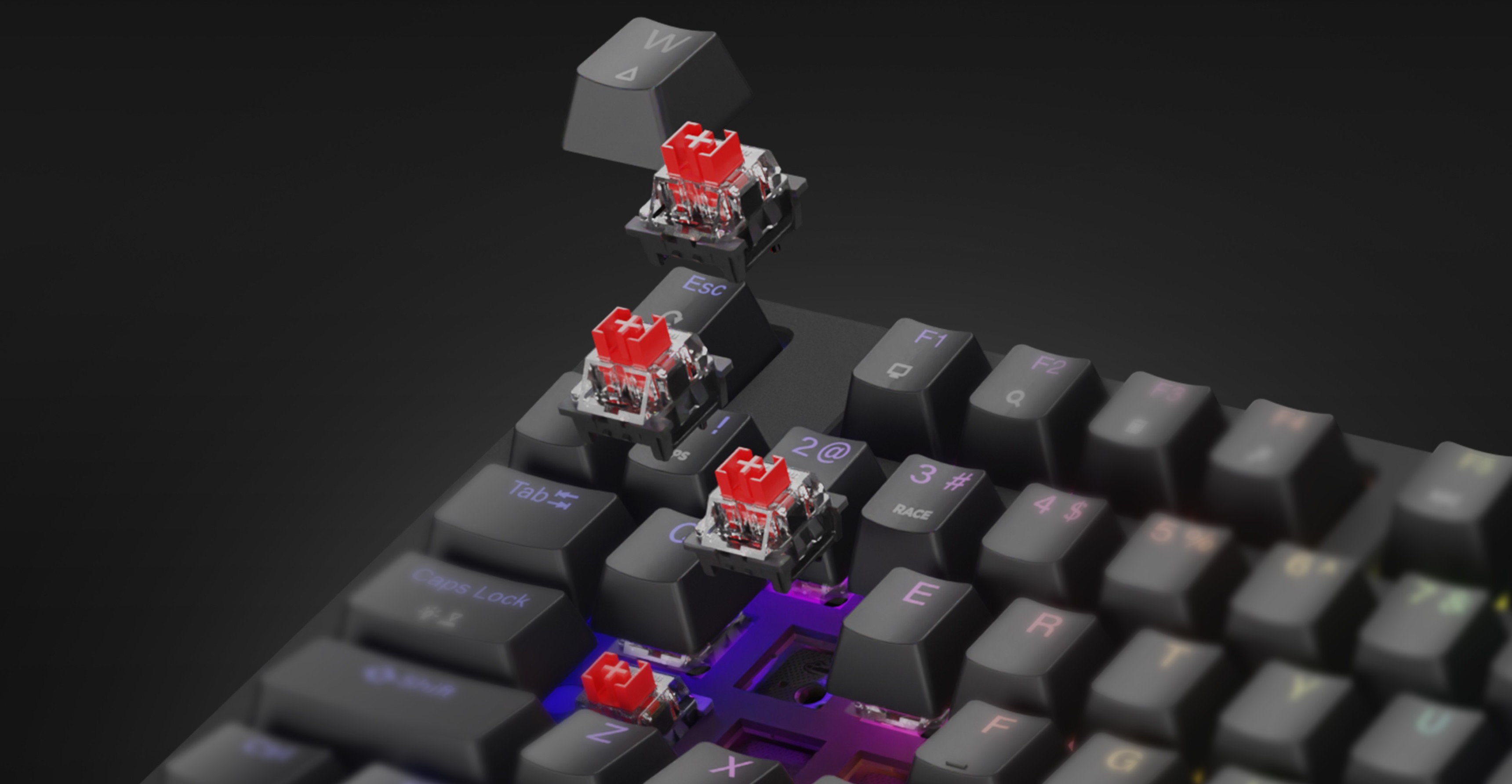 Механическая игровая клавиатура с красными переключателями и радужной RGB-подсветкой, демонстрирующая горячую замену кейкапов и переключателей